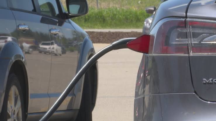 Charging connector plugged into Tesla