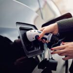 Woman plugging/unplugging EV charging cable